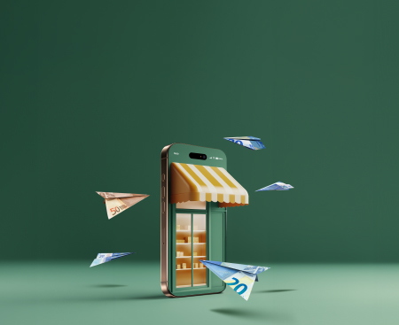 Representació conceptual d'un comerç electrònic sobre un fons verd. Un telèfon intel·ligent simula una botiga física amb un tendal de ratlles grogues i blanques i prestatgeries il·luminades al seu interior. Avions de paper fets amb bitllets de 20 i 50 euros volen al voltant del dispositiu.